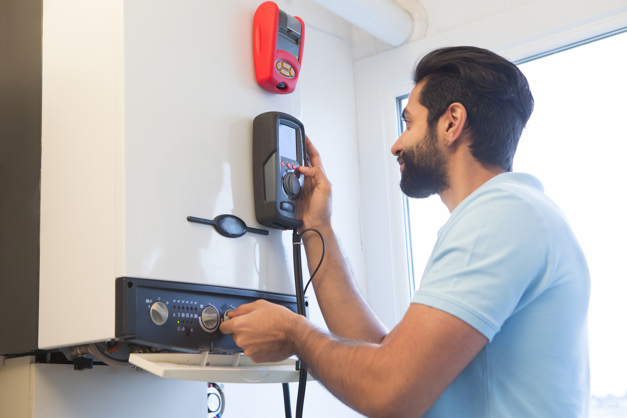 Engineer Servicing Central Heating Boiler